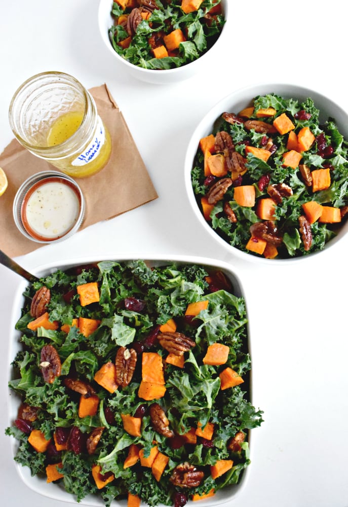 Topped with an easy homemade honey lemon vinaigrette, this roasted sweet potato and kale salad with candied pecans and cranberries is perfect for the holiday season. - isabeleats.com