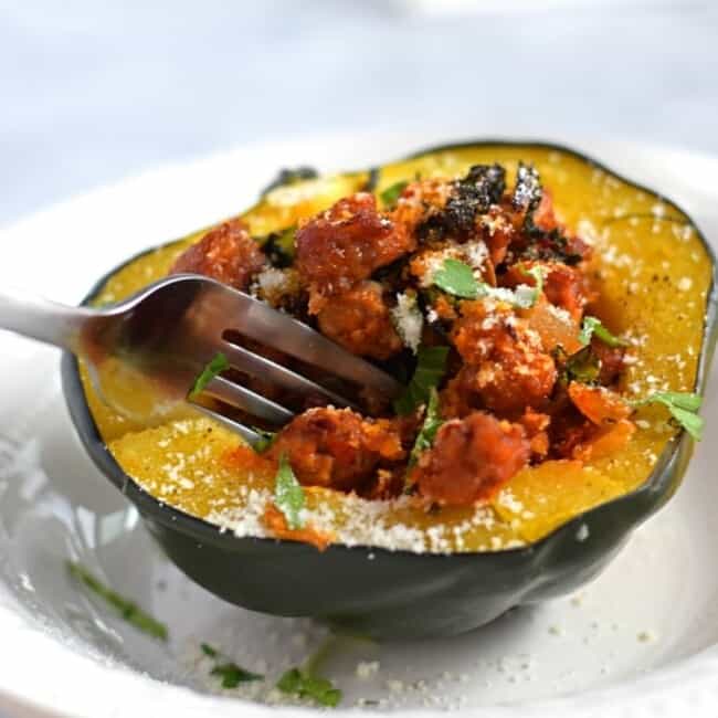 A deliciously simple and seasonal Sausage, Onion & Kale Stuffed Acorn Squash recipe that's perfect for the cold months of winter. (gluten free, paleo) - fromcatstocooking.com
