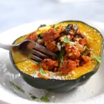 A deliciously simple and seasonal Sausage, Onion & Kale Stuffed Acorn Squash recipe that's perfect for the cold months of winter. (gluten free, paleo) - fromcatstocooking.com