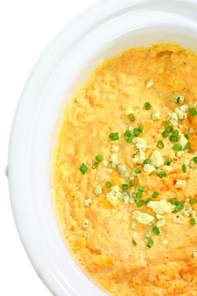 On the party menu is this dangerously good Slow Cooker Buffalo Chicken Dip recipe topped with bleu cheese crumbles and freshly chopped chives. I promise everyone will be asking you for the recipe by the end of the night! - isabeleats.com