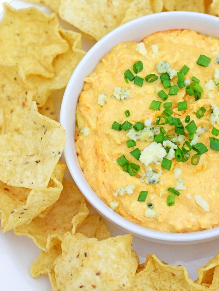 On the party menu is this dangerously good Slow Cooker Buffalo Chicken Dip recipe topped with bleu cheese crumbles and freshly chopped chives. I promise everyone will be asking you for the recipe by the end of the night! - isabeleats.com