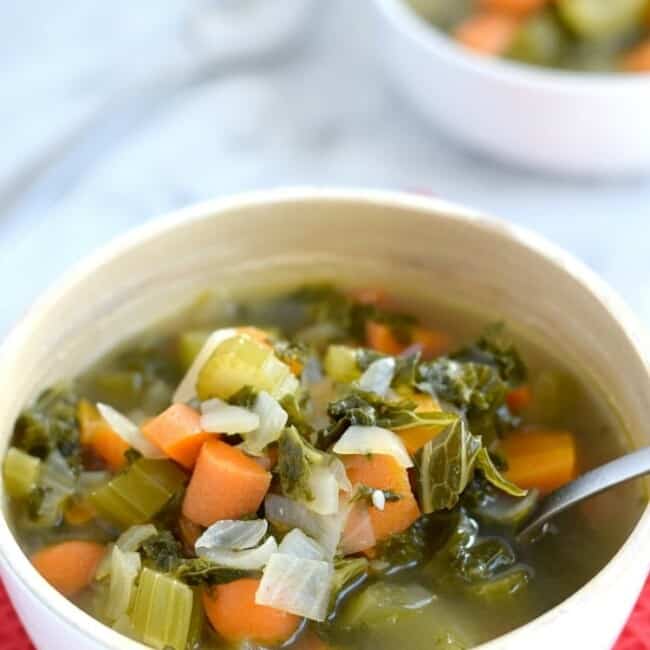 This Winter Kale Vegetable soup is loaded with vegetables like kale, carrots and celery and packed with super savory herbs like rosemary, thyme and garlic. Perfect for the cold winter days. (gluten free, paleo, vegetarian, vegan) - fromcatstocooking.com