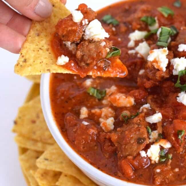Cheesy Spicy Sausage Dip - A spicy, cheesy, tomato-based dip that's delicious with tortilla chips or pita bread. Is gluten free, grain free, paleo and can easily be made dairy free by simply omitting the cheese. Perfect as an appetizer when you're entertaining or just feel like eating some dip.