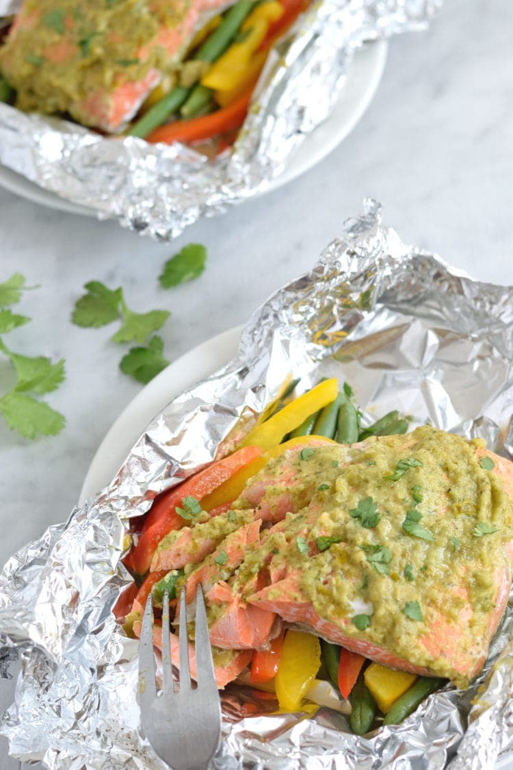Topped with a green chile cilantro sauce, this Mexican Baked Salmon in Foil recipe is easy to make, takes 35 minutes from start to finish and is perfect for lunch and dinner. It's also super healthy and is gluten free, paleo, vegetarian and clean eating.