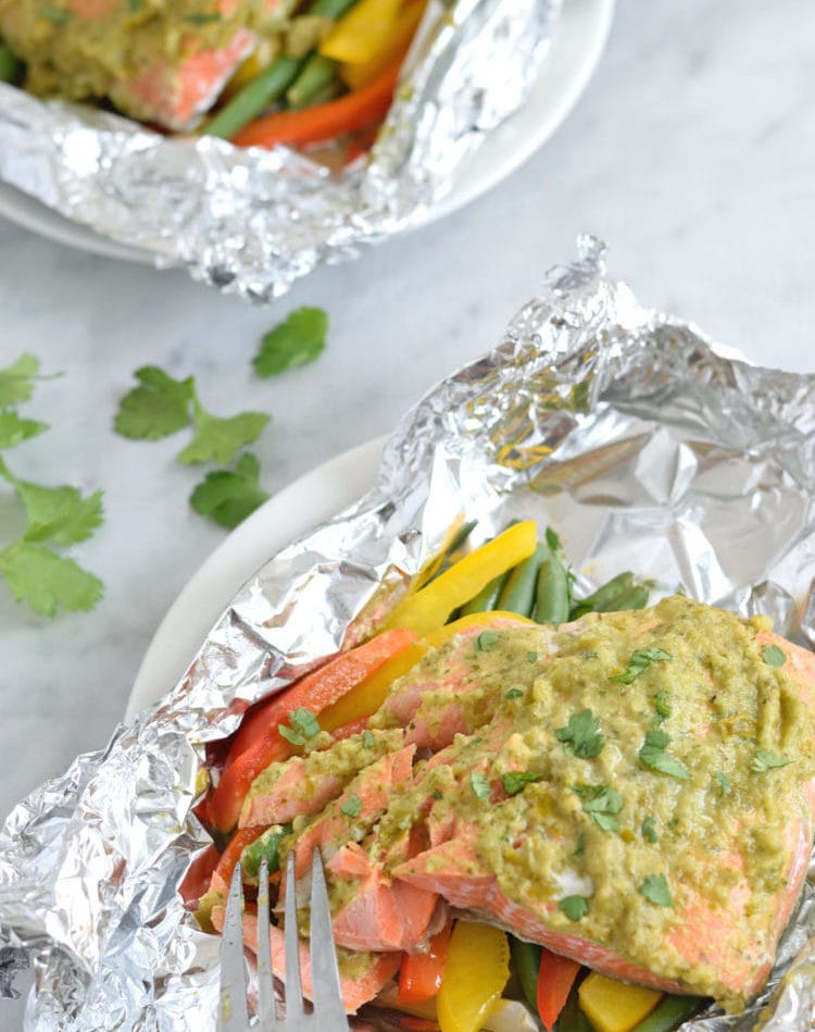 Topped with a green chile cilantro sauce, this Mexican Baked Salmon in Foil recipe is easy to make, takes 35 minutes from start to finish and is perfect for lunch and dinner. It's also super healthy and is gluten free, paleo, vegetarian and clean eating.