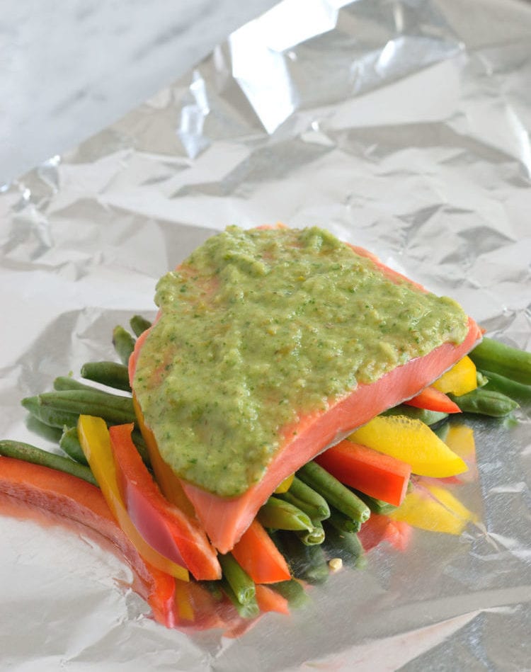 Topped with a green chile cilantro sauce, this Mexican Baked Salmon in Foil recipe is easy to make, takes 35 minutes from start to finish and is perfect for lunch and dinner. It's also super healthy and is gluten free, paleo, vegetarian and clean eating.