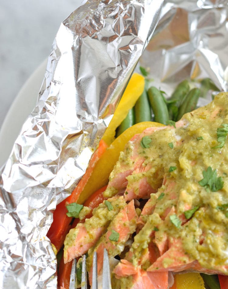 Topped with a green chile cilantro sauce, this Mexican Baked Salmon in Foil recipe is easy to make, takes 35 minutes from start to finish and is perfect for lunch and dinner. It's also super healthy and is gluten free, paleo, vegetarian and clean eating.