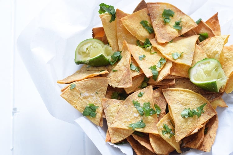 These Homemade Lime Tortilla Chips are crunchy, salty, easy to make and are baked with a hint of lime for a nice little zesty kick. They've taken my chips and salsa game to a whole new level! Perfect on their own as a snack or with some guac or salsa as an appetizer.