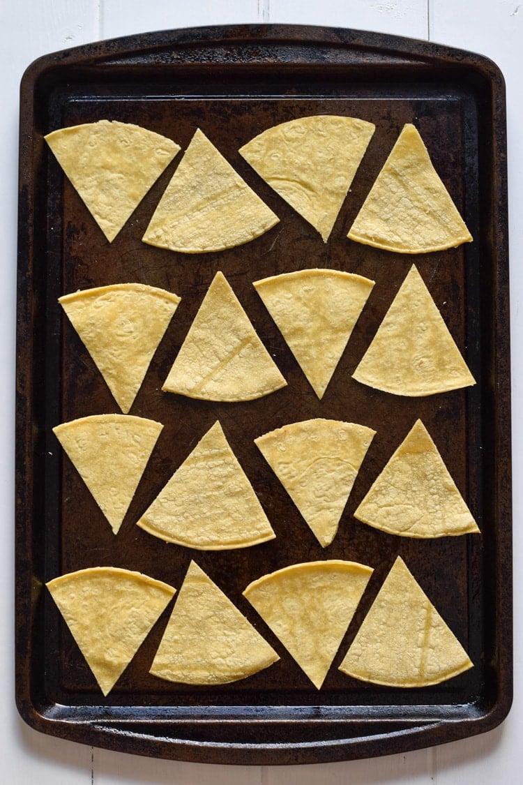 These Homemade Lime Tortilla Chips are crunchy, salty, easy to make and are baked with a hint of lime for a nice little zesty kick. They've taken my chips and salsa game to a whole new level! Perfect on their own as a snack or with some guac or salsa as an appetizer.