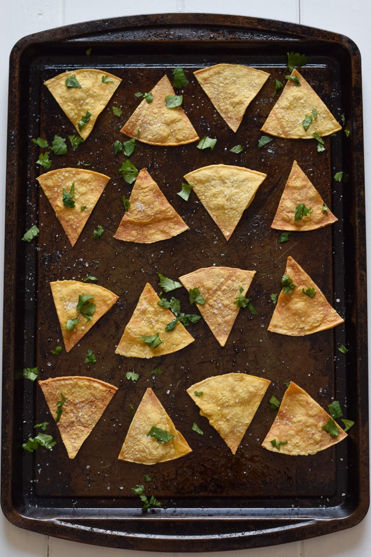 These Homemade Lime Tortilla Chips are crunchy, salty, easy to make and are baked with a hint of lime for a nice little zesty kick. They've taken my chips and salsa game to a whole new level! Perfect on their own as a snack or with some guac or salsa as an appetizer.