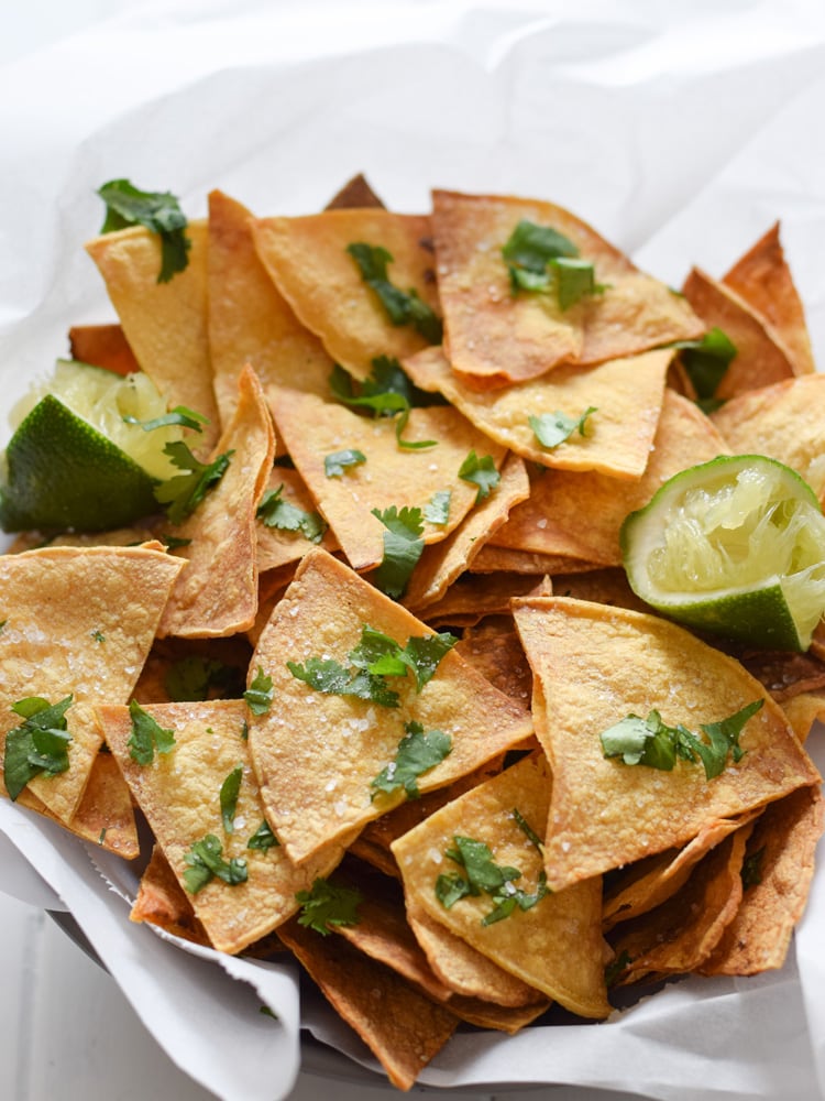 These Homemade Lime Tortilla Chips are crunchy, salty, easy to make and are baked with a hint of lime for a nice little zesty kick. They've taken my chips and salsa game to a whole new level! Perfect on their own as a snack or with some guac or salsa as an appetizer.