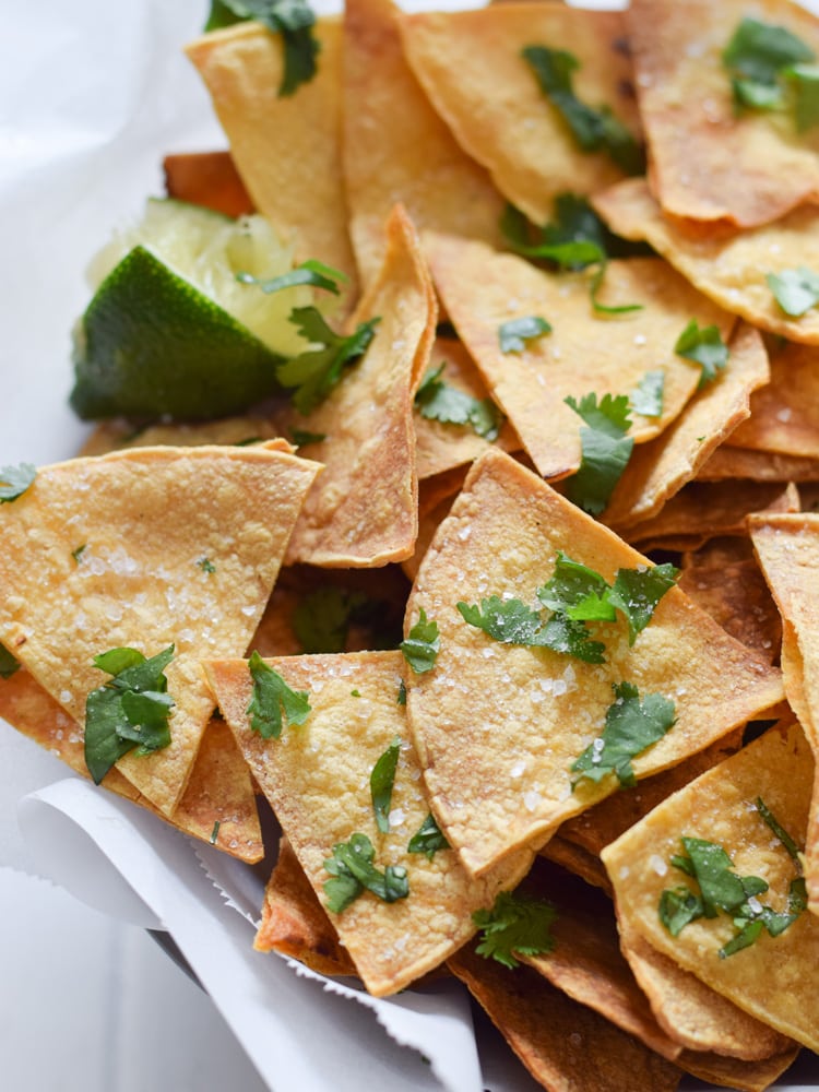 These Homemade Lime Tortilla Chips are crunchy, salty, easy to make and are baked with a hint of lime for a nice little zesty kick. They've taken my chips and salsa game to a whole new level! Perfect on their own as a snack or with some guac or salsa as an appetizer.