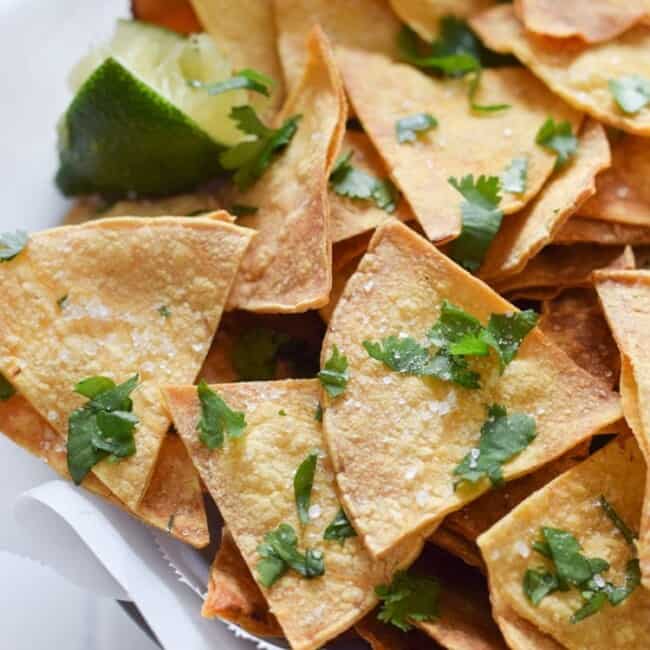 These Homemade Lime Tortilla Chips are crunchy, salty, easy to make and are baked with a hint of lime for a nice little zesty kick. They've taken my chips and salsa game to a whole new level! Perfect on their own as a snack or with some guac or salsa as an appetizer.