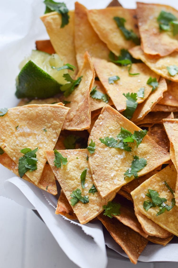 These Homemade Lime Tortilla Chips are crunchy, salty, easy to make and are baked with a hint of lime for a nice little zesty kick. They've taken my chips and salsa game to a whole new level! Perfect on their own as a snack or with some guac or salsa as an appetizer.