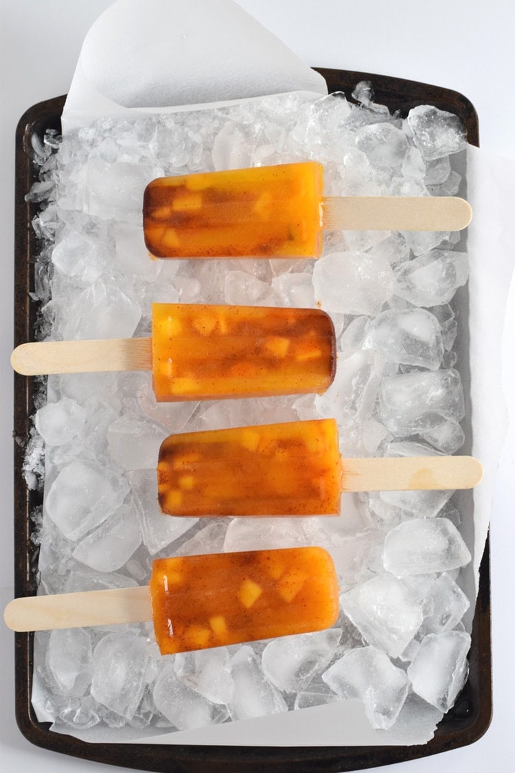 This easy to make Mexican-inspired Mango Chili Popsicle recipe is made with only 4 ingredients and makes a perfect healthy afternoon snack or dessert for those hot summer days.