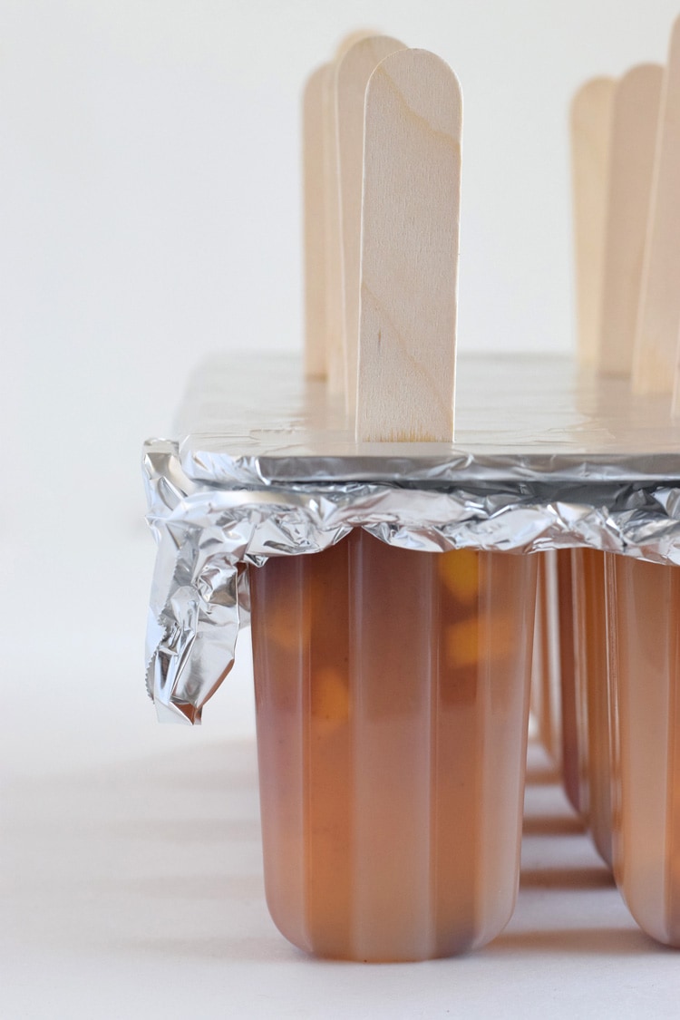 This easy to make Mexican-inspired Mango Chili Popsicle recipe is made with only 4 ingredients and makes a perfect healthy afternoon snack or dessert for those hot summer days.