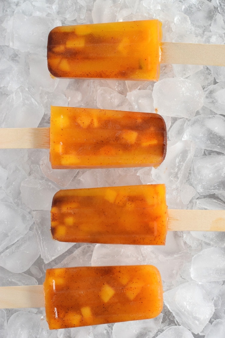 This easy to make Mexican-inspired Mango Chili Popsicle recipe is made with only 4 ingredients and makes a perfect healthy afternoon snack or dessert for those hot summer days.