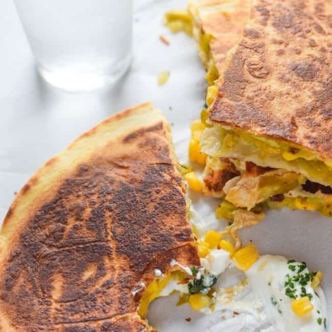 These Easy Green Chile & Corn Quesadillas take only 12 minutes to make, are an easy lunch or dinner option and are vegetarian friendly! Plus, they're also an inexpensive meal. All you need are some flour tortillas, canned corn, canned diced green chiles and shredded cheese!