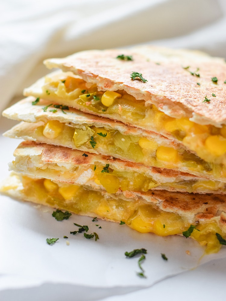 These Easy Green Chile Corn Quesadillas take only 12 minutes to make, are an easy lunch or dinner option and are vegetarian friendly! Plus, they're also an inexpensive meal. All you need are some flour tortillas, canned corn, canned diced green chiles and shredded cheese!