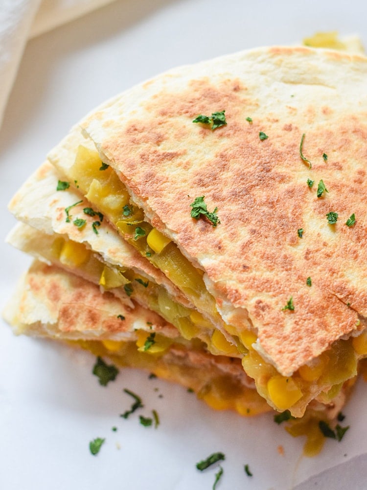 These Easy Green Chile Corn Quesadillas take only 12 minutes to make, are an easy lunch or dinner option and are vegetarian friendly! Plus, they're also an inexpensive meal. All you need are some flour tortillas, canned corn, canned diced green chiles and shredded cheese!