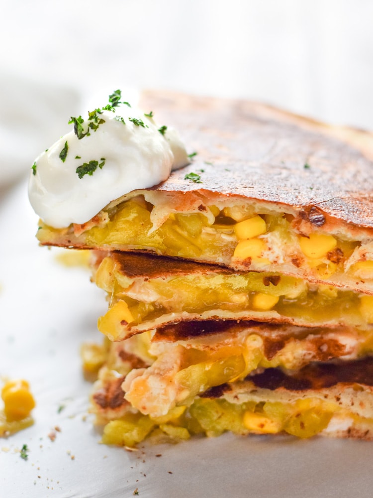 These Easy Green Chile Corn Quesadillas take only 12 minutes to make, are an easy lunch or dinner option and are vegetarian friendly! Plus, they're also an inexpensive meal. All you need are some flour tortillas, canned corn, canned diced green chiles and shredded cheese!