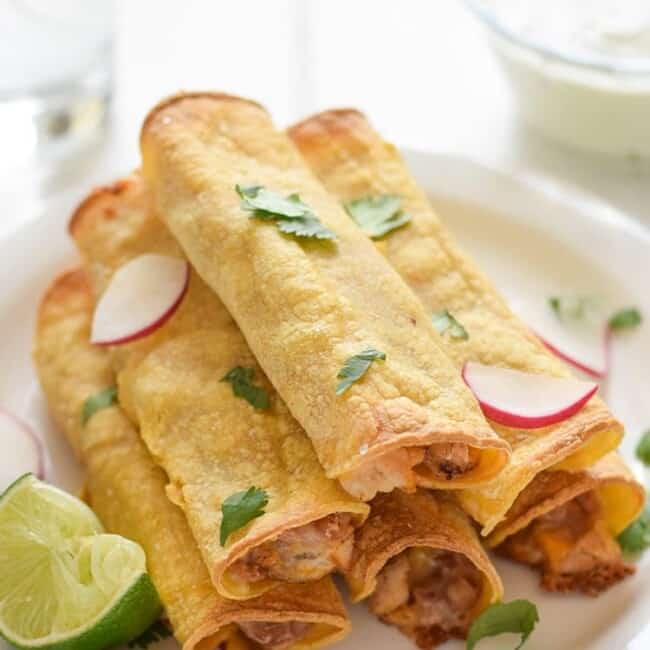 If you're looking for an easy, freezer-friendly meal, look no further than these Baked Chicken, Bean & Cheese Taquitos. Loaded with mashed pinto beans, shredded Mexican cheese and chili-spiced baked chicken, these taquitos are just like your favorite tacos, but even more fun to eat!