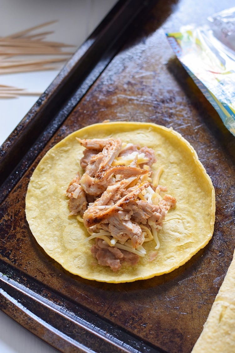 If you're looking for an easy, freezer-friendly meal, look no further than these Baked Chicken, Bean & Cheese Taquitos. Loaded with mashed pinto beans, shredded Mexican cheese and chili-spiced baked chicken, these taquitos are just like your favorite tacos, but even more fun to eat!