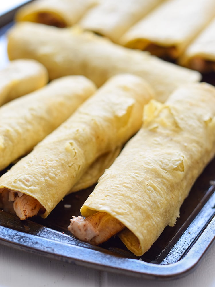 If you're looking for an easy, freezer-friendly meal, look no further than these Baked Chicken, Bean & Cheese Taquitos. Loaded with mashed pinto beans, shredded Mexican cheese and chili-spiced baked chicken, these taquitos are just like your favorite tacos, but even more fun to eat!