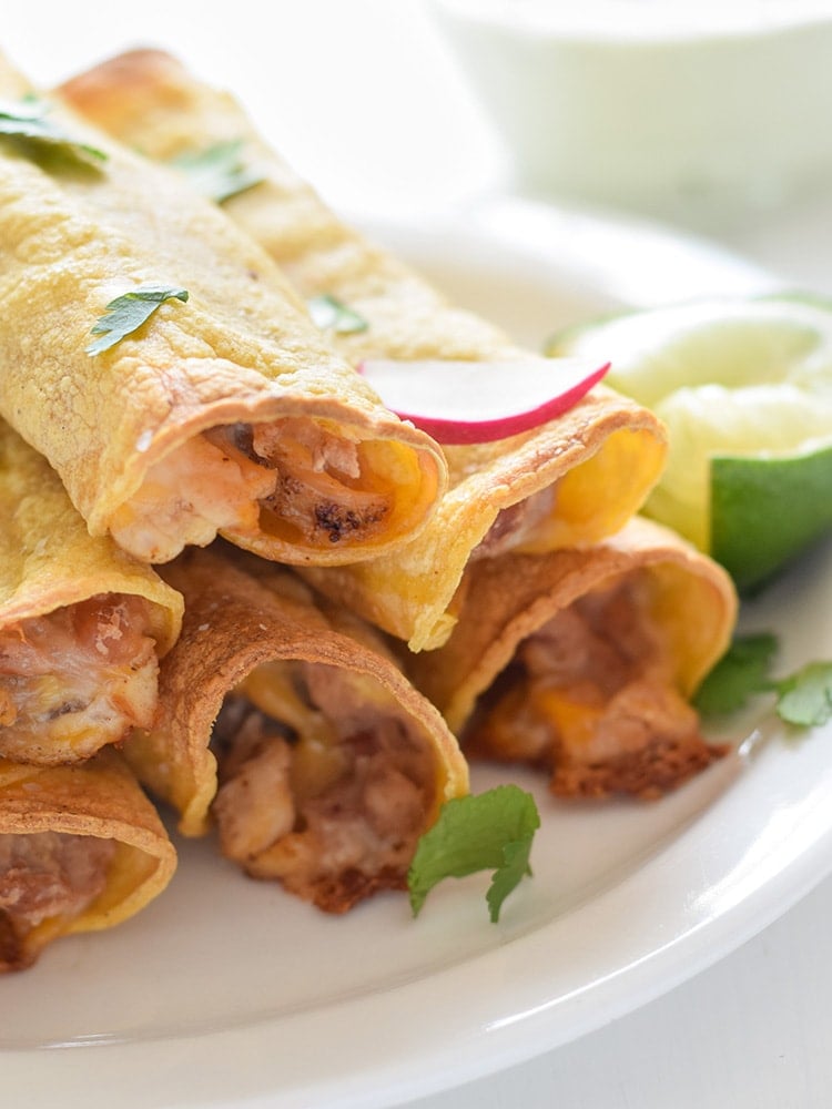 If you're looking for an easy, freezer-friendly meal, look no further than these Baked Chicken, Bean & Cheese Taquitos. Loaded with mashed pinto beans, shredded Mexican cheese and chili-spiced baked chicken, these taquitos are just like your favorite tacos, but even more fun to eat!