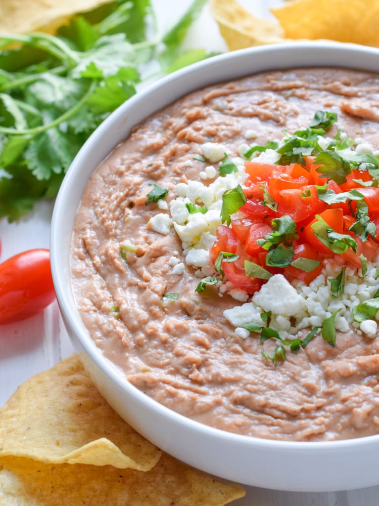 This creamy bean dip recipe is made with cream cheese, Mexican spices and diced jalapenos. It's easy to make and is the perfect appetizer or snack!