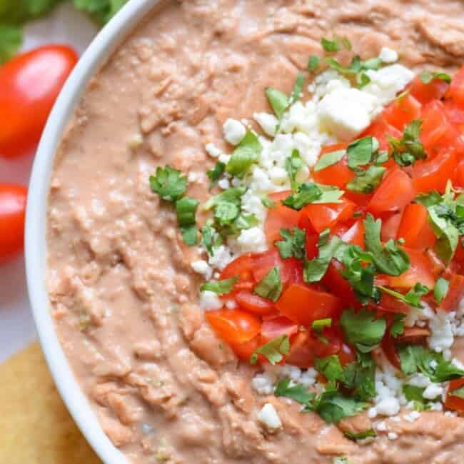 Mixed with cream cheese, Mexican spices and diced jalapenos, this creamy bean dip recipe is easy to make and is the perfect appetizer or snack!