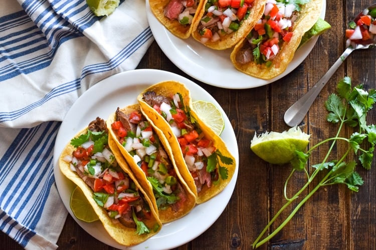 Topped with fresh pico de gallo salsa for an added crunch, these easy-to-make Marinated Flank Steak Tacos are juicy, bright and super flavorful. Perfect for any weeknight meal! (gluten free, dairy free, paleo)