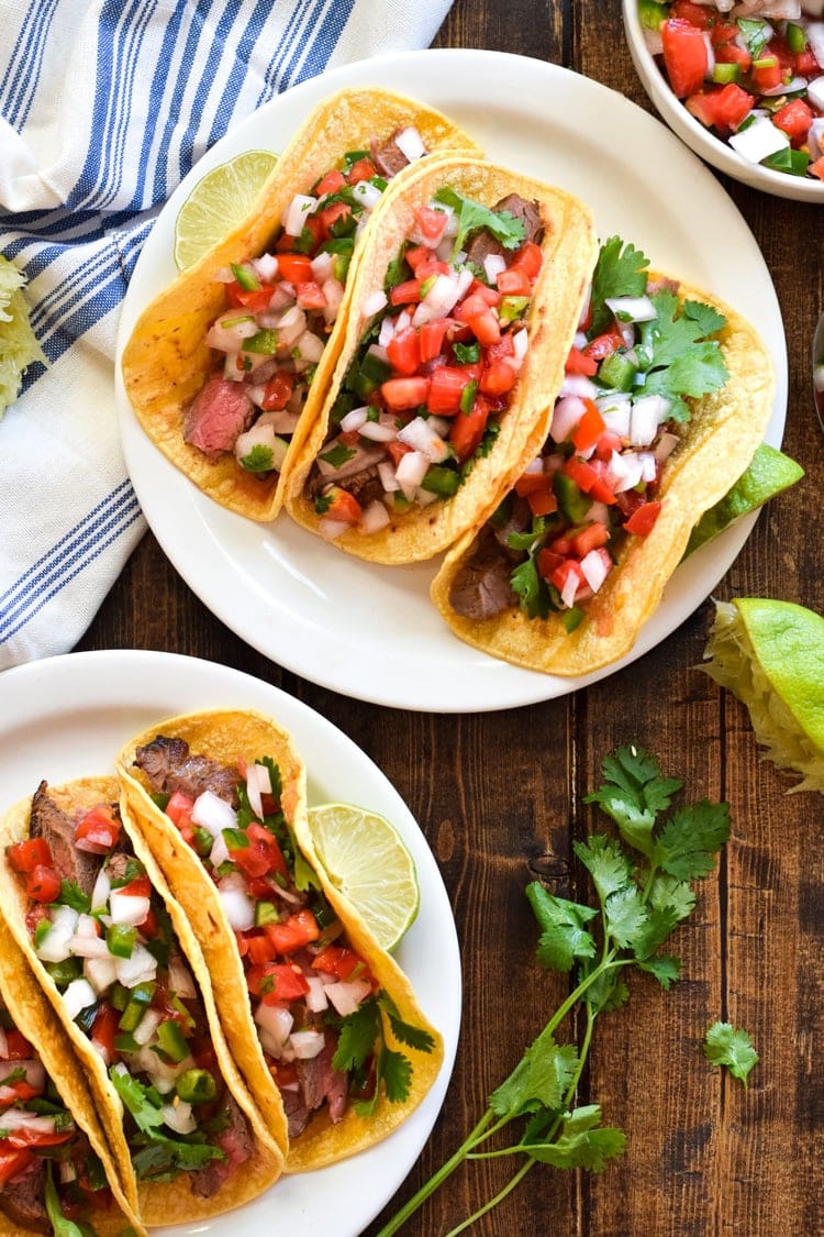 Topped with fresh pico de gallo salsa for an added crunch, these easy-to-make Marinated Flank Steak Tacos are juicy, bright and super flavorful. Perfect for any weeknight meal! (gluten free, dairy free, paleo)
