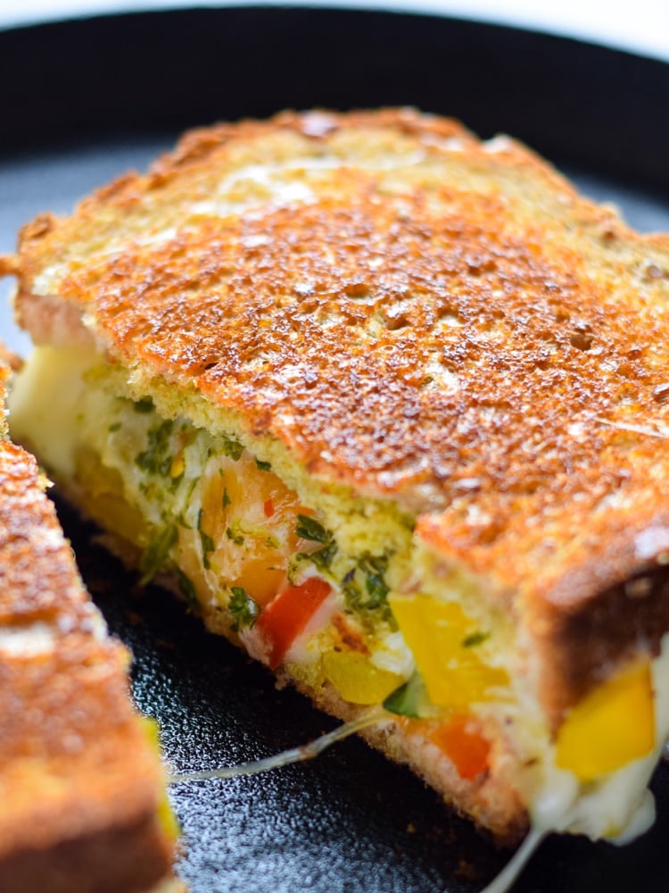 Made with sautéed vegetables, a cilantro parsley chimichurri spread and lots of melted cheese, this Mexican Fajita Grilled Cheese will leave you full and oh so happy. (vegetarian)