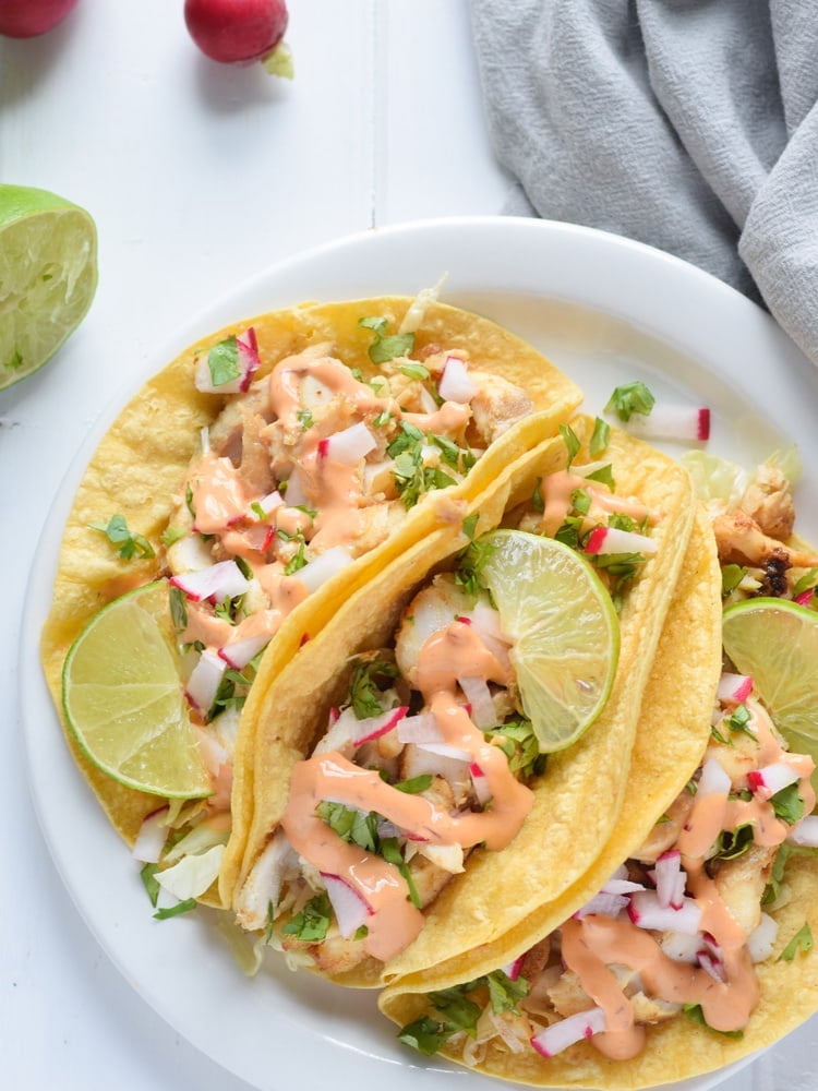 Made with a bright and creamy chipotle lime crema made with greek yogurt and lime juice, these Fish Tacos take only 15 minutes to make and are gluten free!