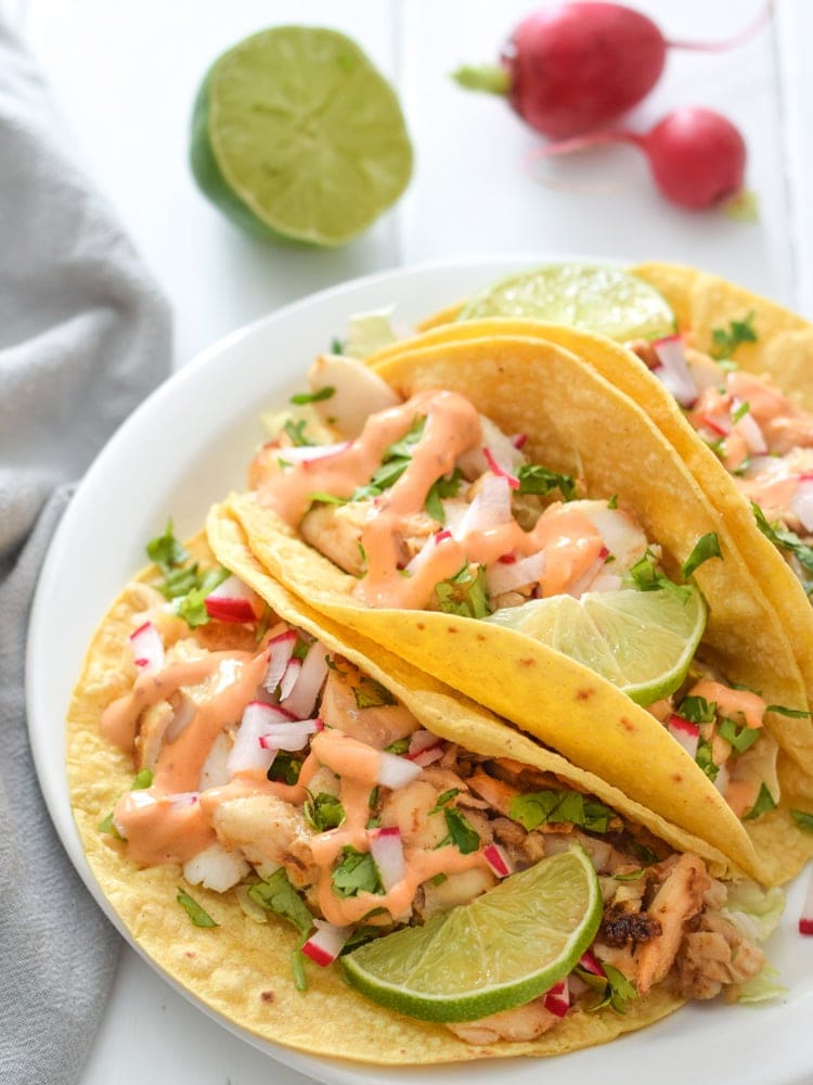 Made with a bright and creamy chipotle lime crema made with greek yogurt and lime juice, these Fish Tacos take only 15 minutes to make and are gluten free!