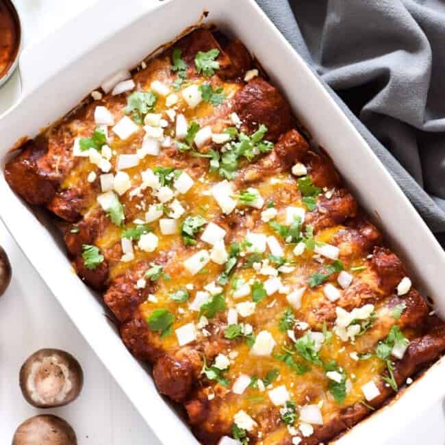 These Spinach Enchiladas are covered in a red enchilada sauce and stuffed with spinach, mushrooms and onions for a tasty Mexican dinner!