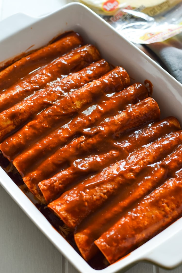 spinach enchiladas topped with enchilada sauce