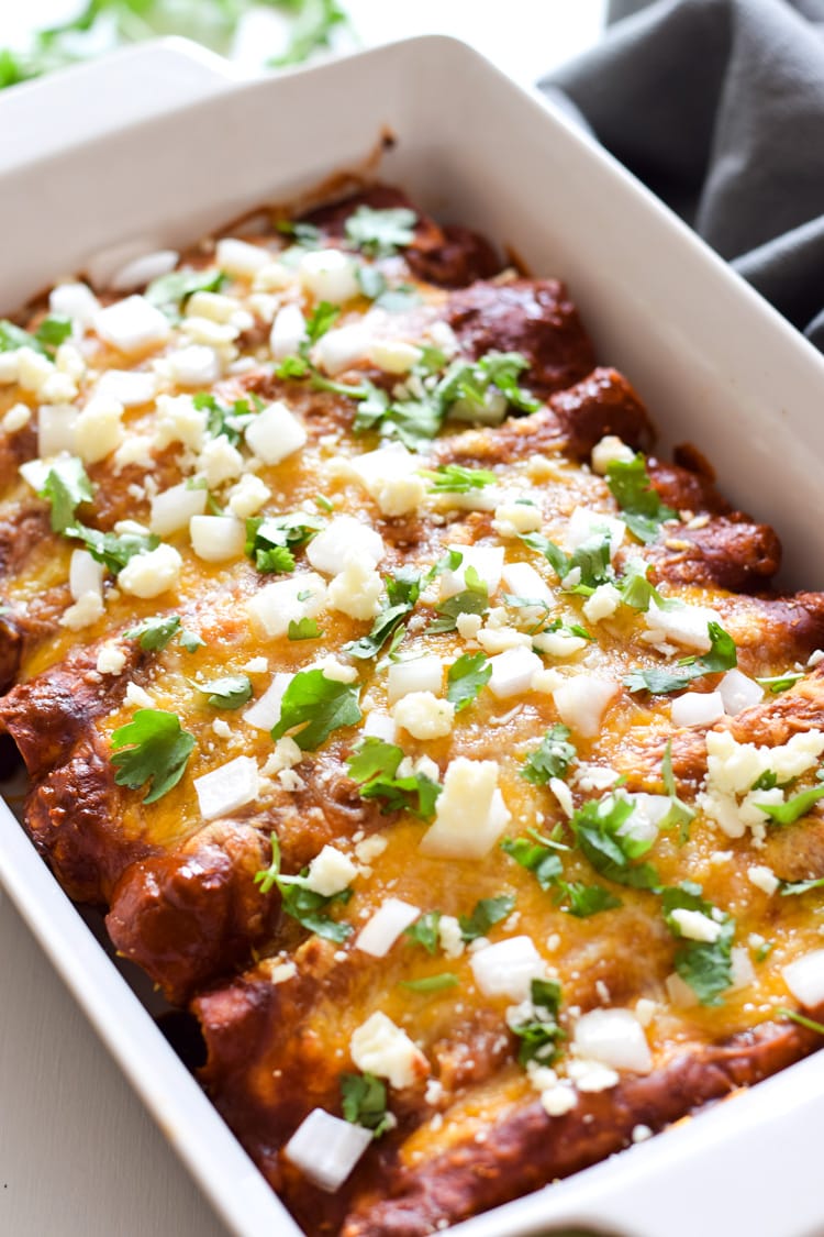 These Spinach Enchiladas are covered in a red enchilada sauce and stuffed with spinach, mushrooms and onions for a tasty Mexican dinner!