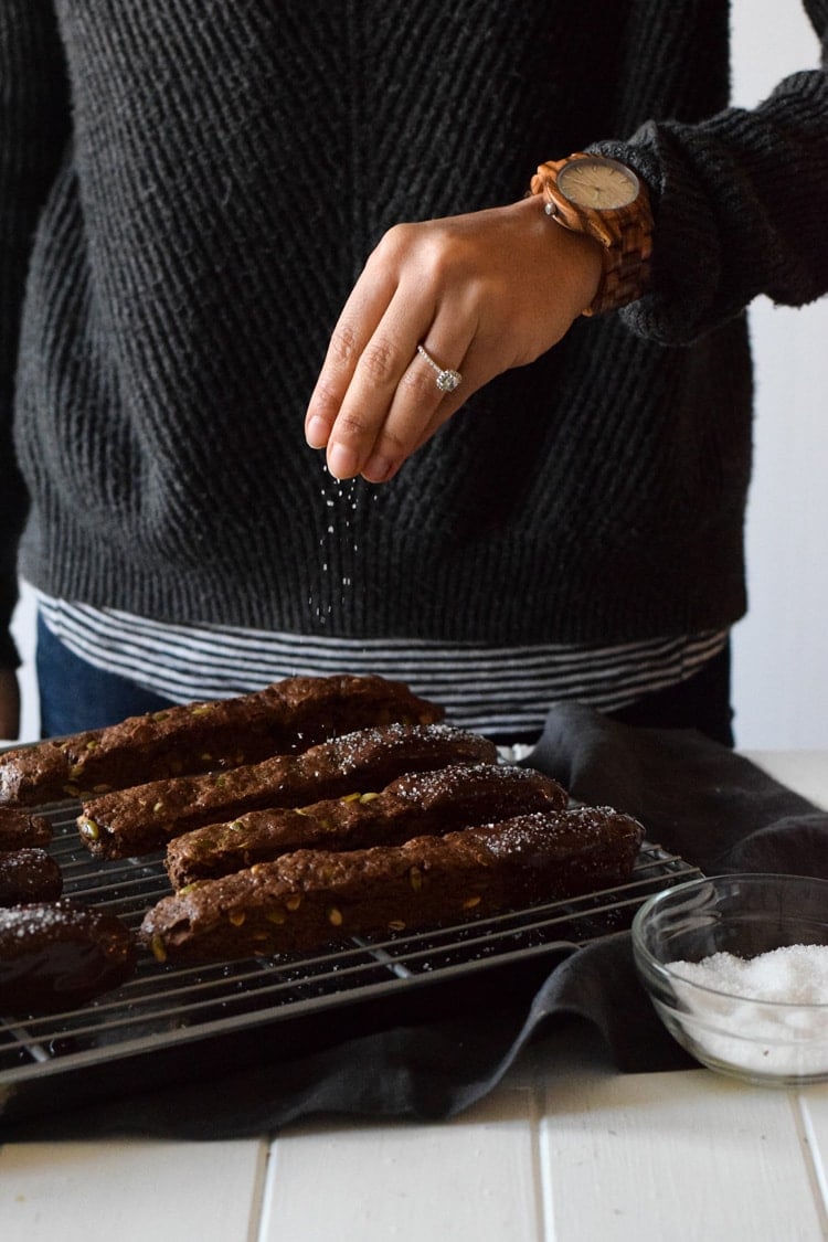 Homemade Mexican Chocolate Pumpkin Seed Biscotti dipped in melted chocolate and sprinkled with sea salt. Holiday perfection. Featuring JORD Wood Watch - Fieldcrest Zebrawood and Maple