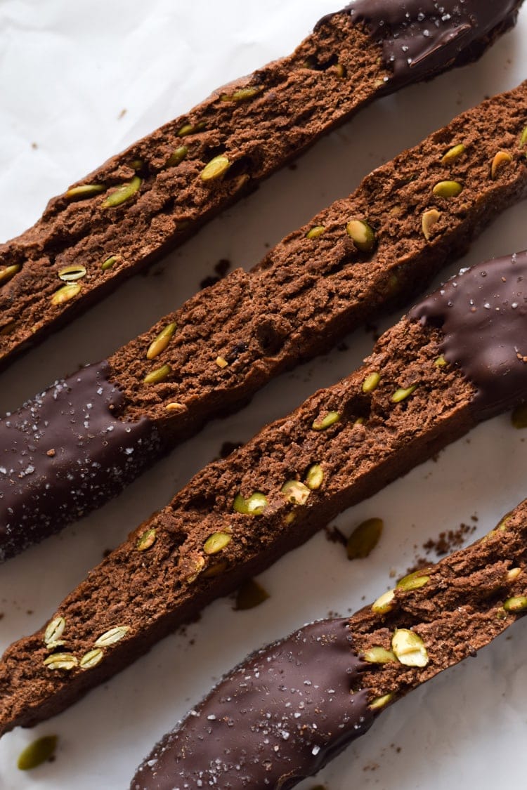Homemade Mexican Chocolate Pumpkin Seed Biscotti dipped in melted chocolate and sprinkled with sea salt. Holiday perfection.