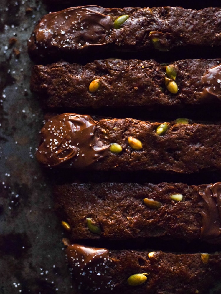 Homemade Mexican Chocolate Pumpkin Seed Biscotti dipped in melted chocolate and sprinkled with sea salt. Holiday perfection.