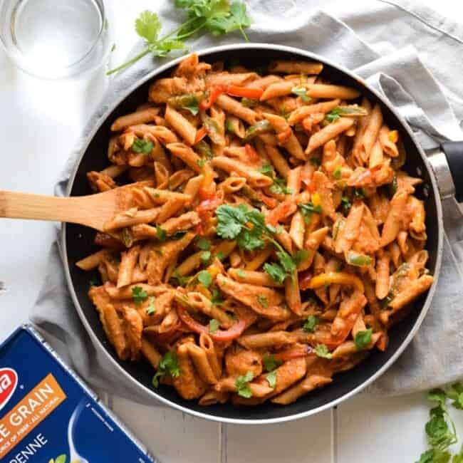 Filled with colorful bell peppers in a light yet creamy chili tomato sauce, this Healthy Chicken Fajita Pasta is perfect for those busy nights when you need to get something delicious yet healthy on the table quickly.