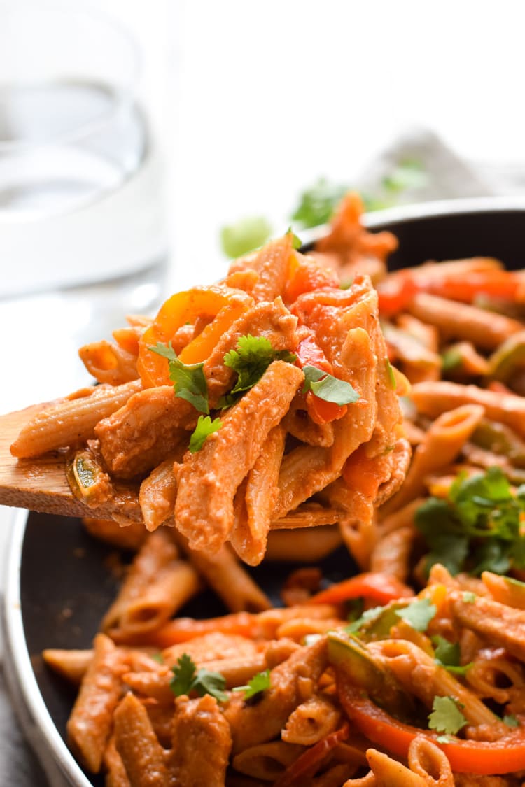 Filled with colorful bell peppers in a light yet creamy chili tomato sauce, this Healthy Chicken Fajita Pasta is perfect for those busy nights when you need to get something delicious yet healthy on the table quickly.