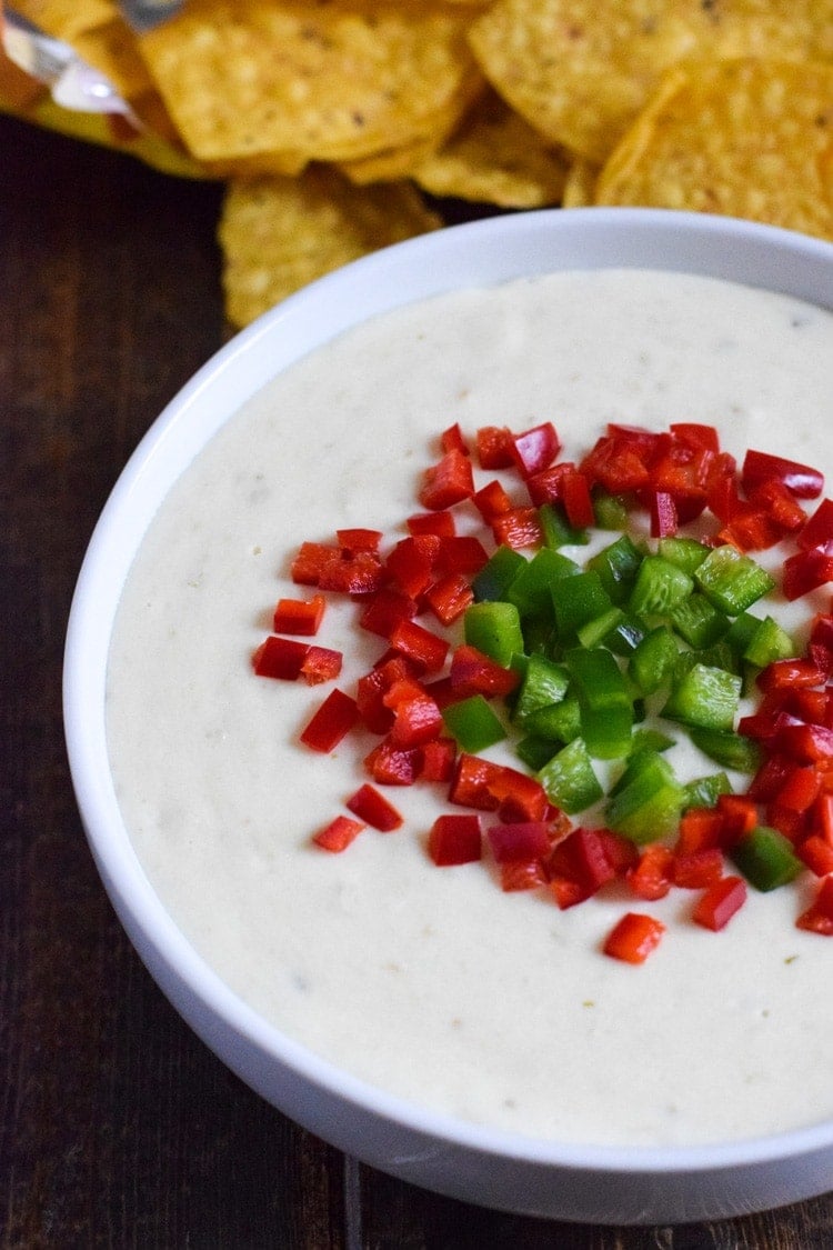 This easy, cheesy and super creamy Salsa Verde Queso Dip made in the slow cooker is the perfect no-fuss appetizer for your next game day party! (gluten free, vegetarian, low carb, crock pot)