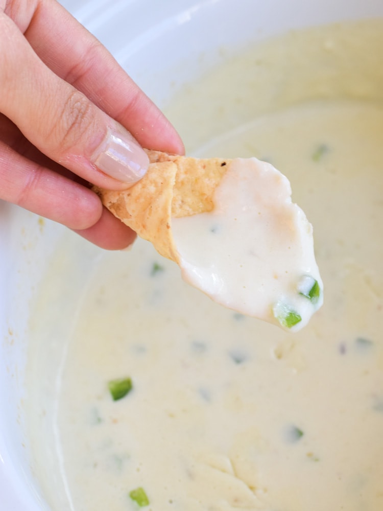 This easy, cheesy and super creamy Salsa Verde Queso Dip made in the slow cooker is the perfect no-fuss appetizer for your next game day party! (gluten free, vegetarian, low carb, crock pot)