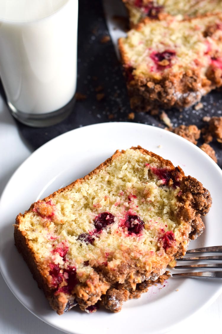 This Cranberry Banana Bread topped with a cinnamon granola crunch is super moist, fluffy and filled with cranberries. Perfect for the holidays!