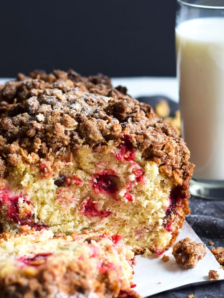 This Cranberry Banana Bread topped with a cinnamon granola crunch is super moist, fluffy and filled with cranberries. Perfect for the holidays!