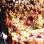 This Cinnamon Cranberry Crunch Banana Bread is super moist, fluffy, filled with cranberries and topped with a granola crumble. Perfect for the holidays!