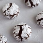 Classic holiday Chocolate Crinkle Cookies with a twist! Made with coconut oil and Abuelita Mexican chocolate, these festive cookies are soft, chewy and covered in powdered sugar.